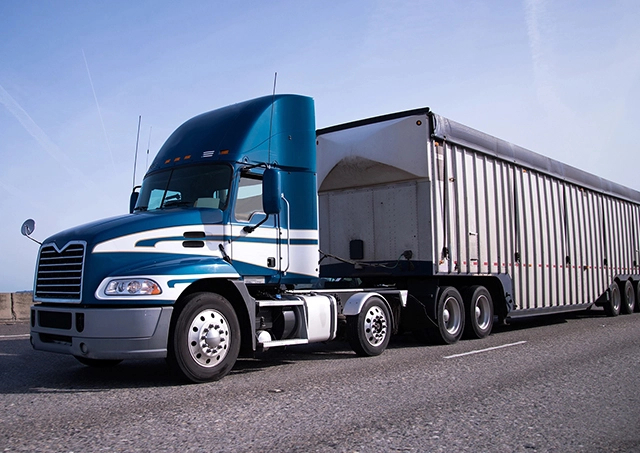 Best commercial truck loan interest rates with Easy Truck Finance for a blue rig semi truck on a highway