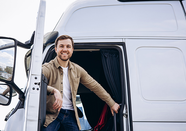 Truck loans tailored for you via chattel mortgage for a truck driver sitting in the cab of his lorry