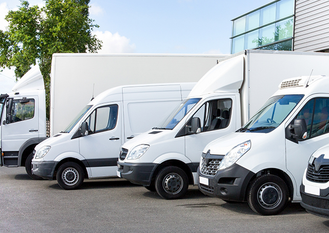 CHP financing for commercial trucks with flexible rates for heavy vehicles parked in a lot outside a logistics facility