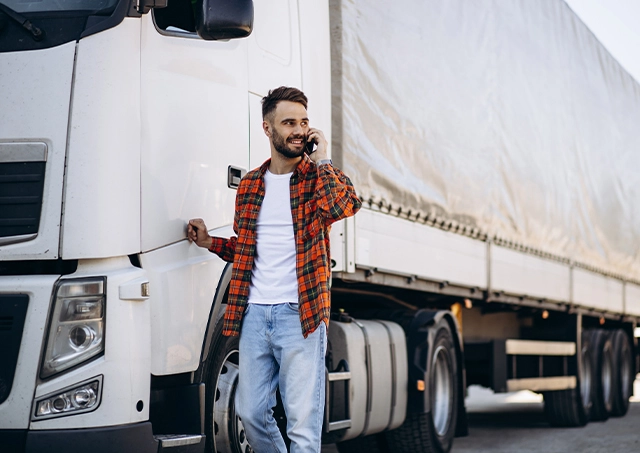 Truck finance brokers australia finalised finance terms over the phone with a driver leaning on a white truck