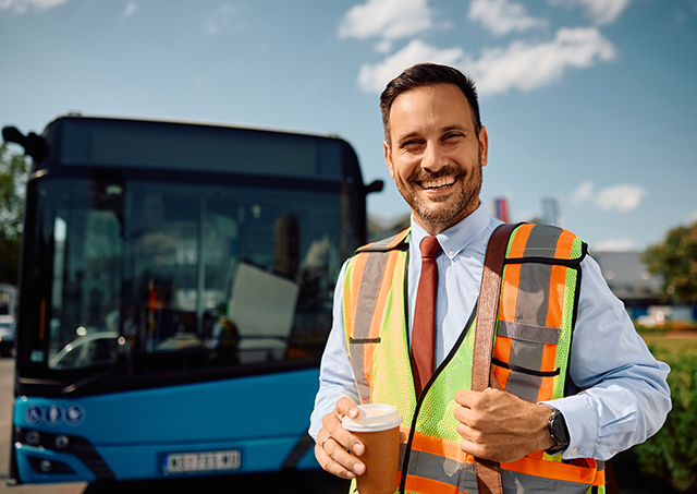 Commercial bus finance packages helping a smiling transport operator secure a new blue passenger vehicle