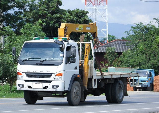 Flexible commercial lifting equipment loans utilised to acquire a white flatbed truck fitted with a hydraulic truck-mounted crane