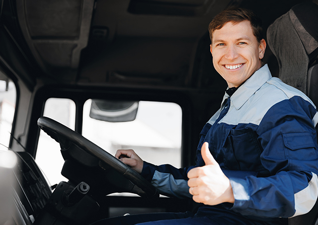 Truck finance for all businesses with easy access to the best rates, featuring a truck driver driving his lorry with a thumbs-up gesture